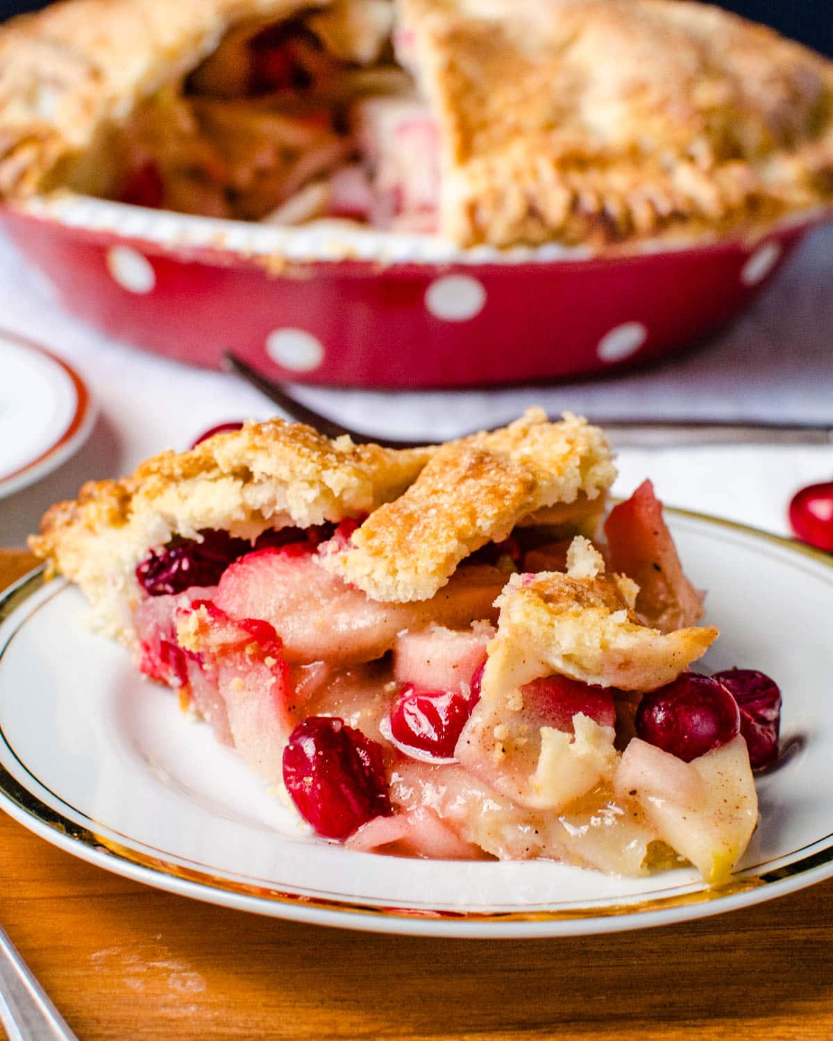 Apple cranberry pie on a plate.