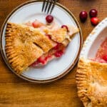 Serving a slice of apple cranberry pie.