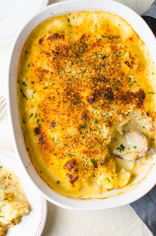 spooning out the gratin onto a dish.