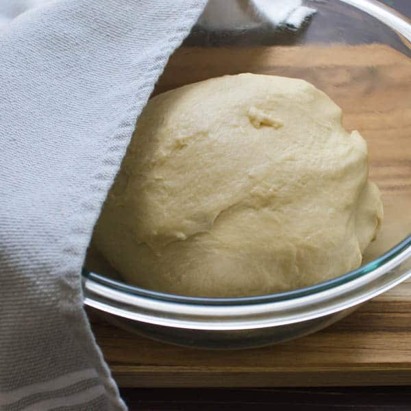 dough in a bowl with towel
