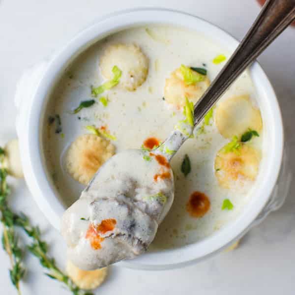 spooning an oyster from a bowl of Classic Oyster Stew