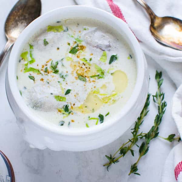 Classic Oyster Stew in a bowl. with spoon.