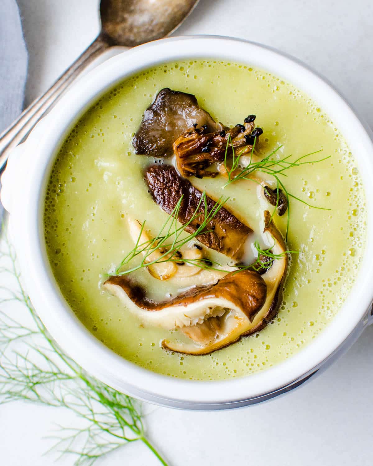 A bowl of fennel leek soup with mushrooms.
