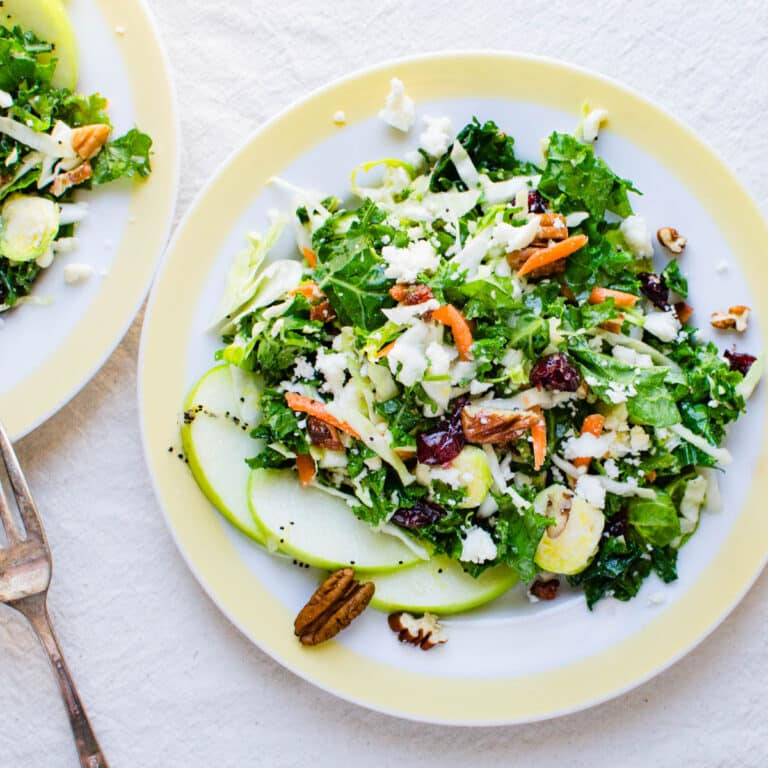 Cabbage and kale salad on a yellow-rimmed plate.