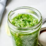 A jar of fresh tomatillo salsa.