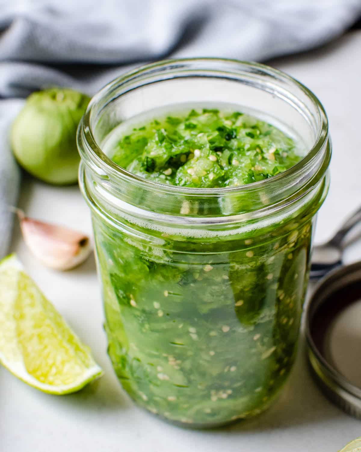 A jar of fresh tomatillo salsa.