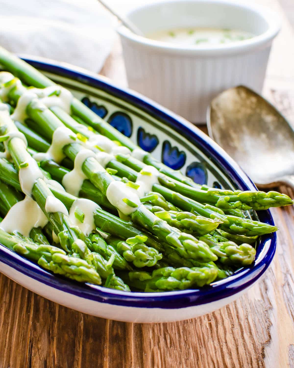 Serving cooked asparagus with Dijon dressing.