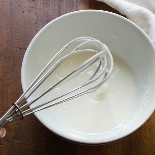 whisking glaze for coffee cake in a bowl.
