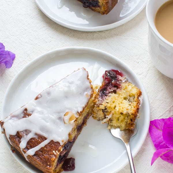 Overhead shot of Cherry Almond Coffee Cake with a cup of coffee.