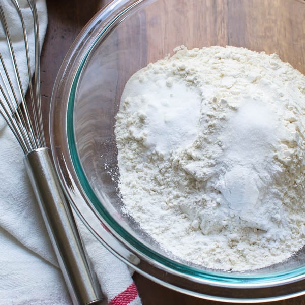 flour, salt and learners in a bowl with a whisk.