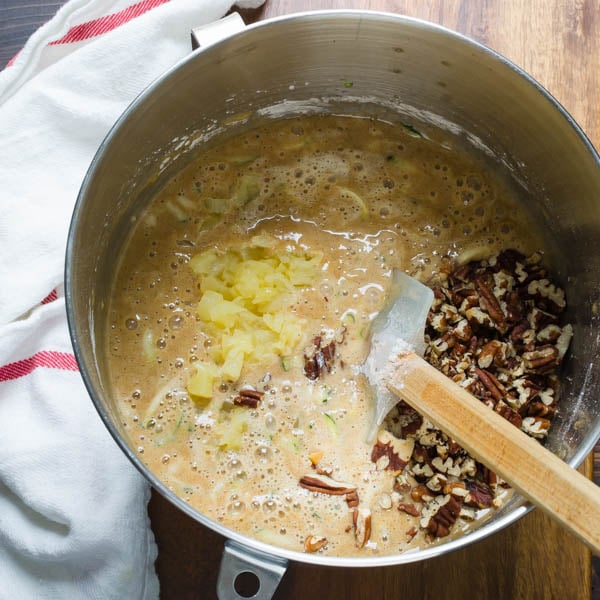 stirring in pineapple and chopped pecans to the batter.