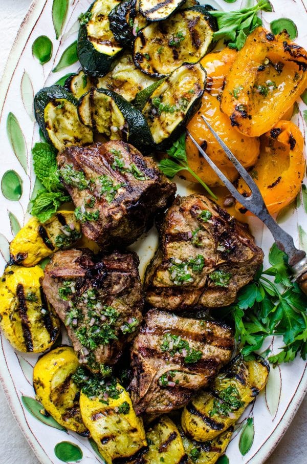 platter of mint chimichurri lamb chops with grilled vegetables.