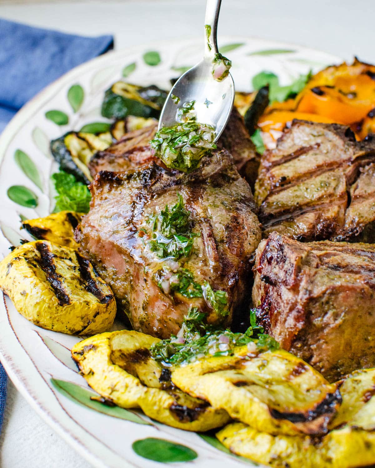 Serving lamb chops and grilled vegetables with mint chimichurri.