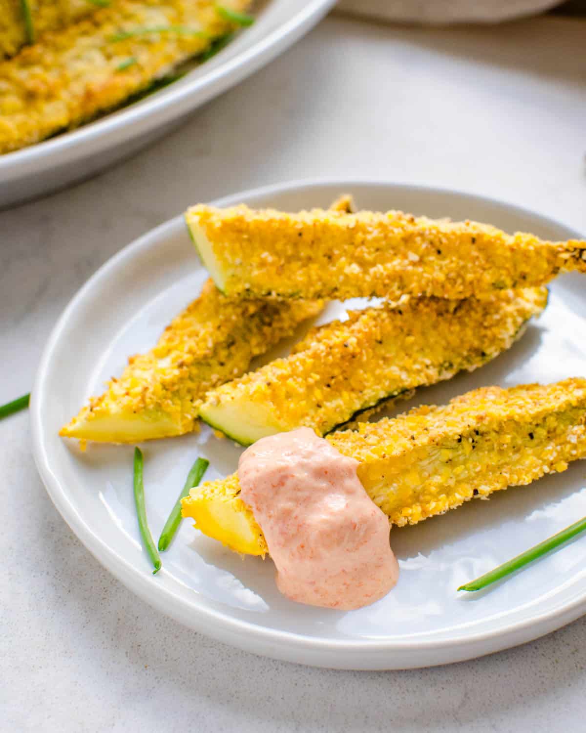 A plate of zucchini fries with aioli.