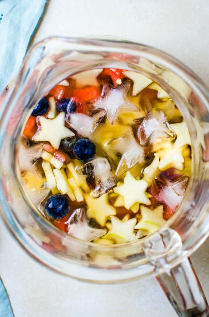 a beautiful pitcher of sangria with star shaped fruit.