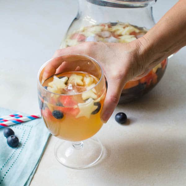 Reaching for a glass of Red White and Blue Sangria