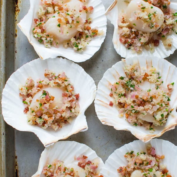 sea scallops with breadcrumbs and pancetta on a baking sheet.