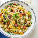Lemon orzo salad with chicken in a white serving bowl.