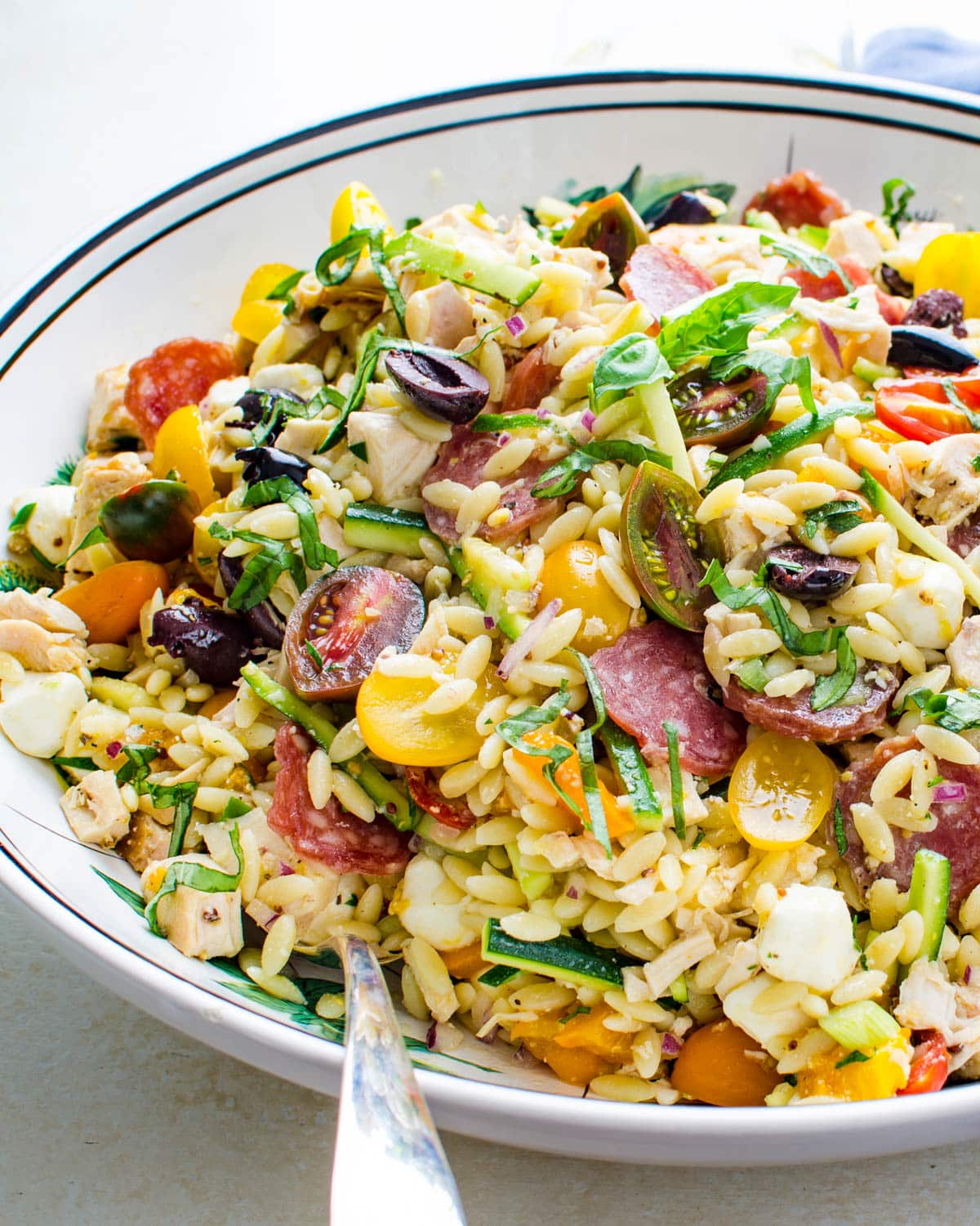 orzo chicken salad with pepperoni and veggies in a bowl.
