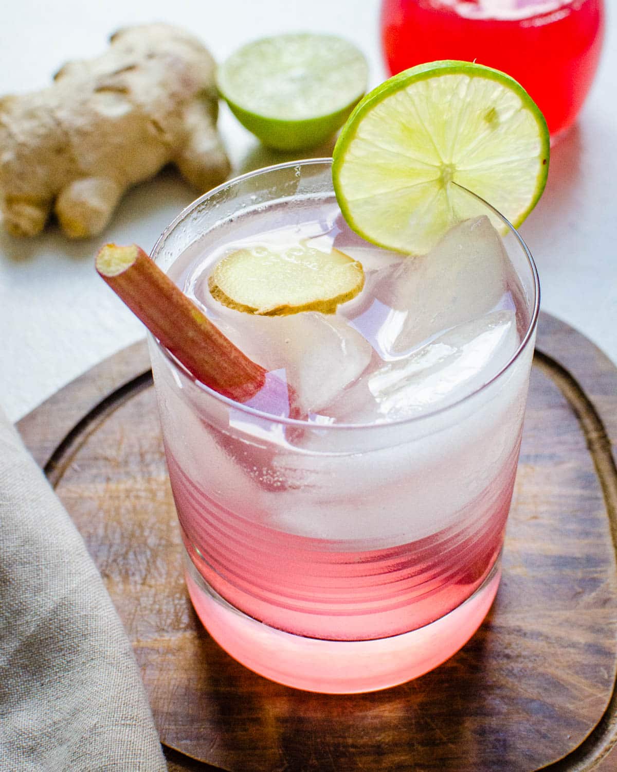 A rhubarb gin cocktail with a lime garnish.