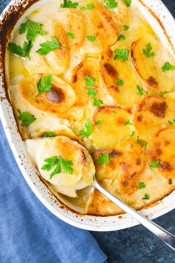 scooping Simple Scalloped Potatoes a delicious fall side dish.