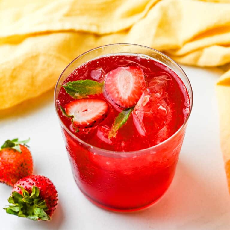 Strawberry rhubarb lemonade with strawberry slices.