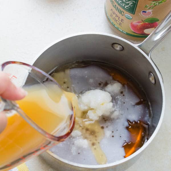 adding apple juice to maple syrup and coconut oil