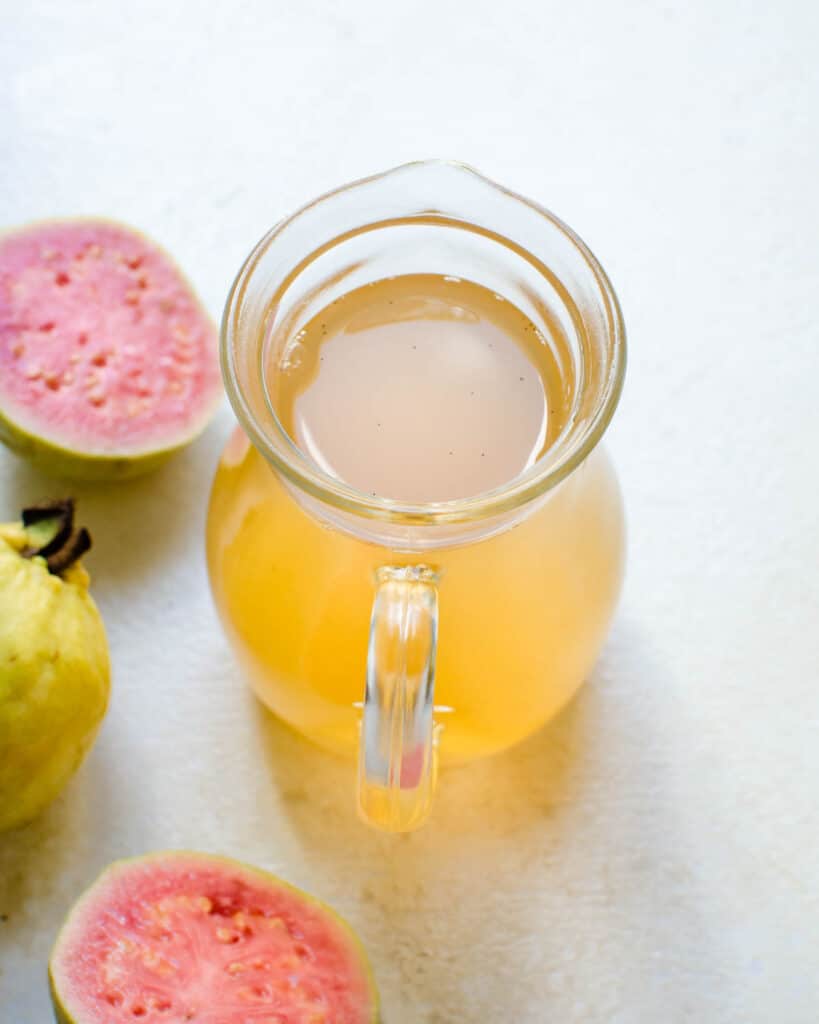 A pitcher of guava simple syrup.