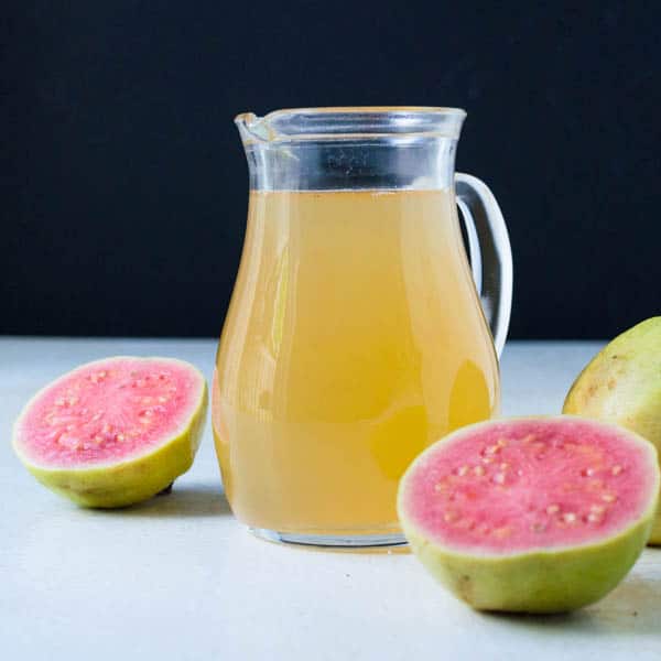 Guava Vanilla Simple Syrup with cut guava fruit.