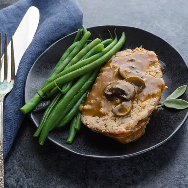 Meatloaf with Mushroom Gravy on a plate.