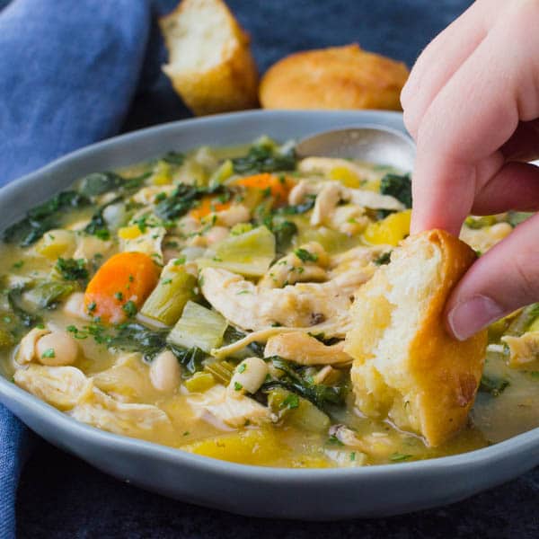 Dipping bread into easy chicken stew with fall vegetables.