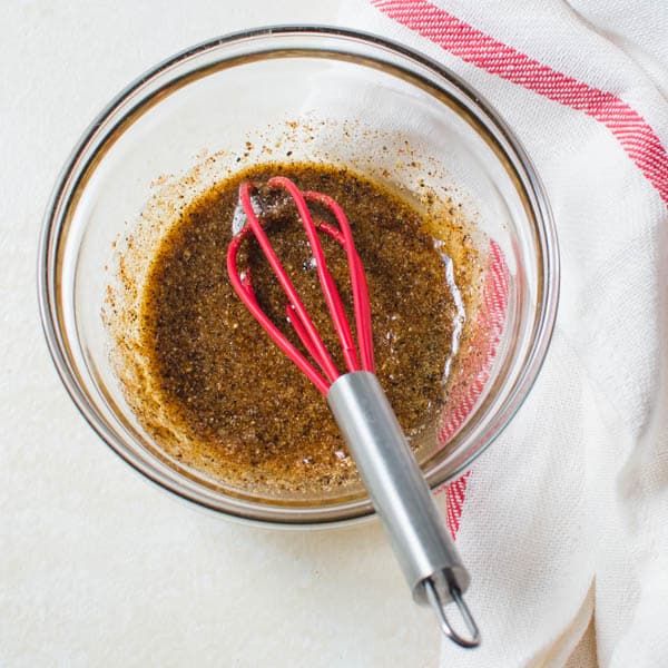 Roast beef rub in a bowl with whisk.