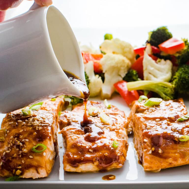 drizzling hoisin maple glaze over the sheet pan salmon and vegetables.