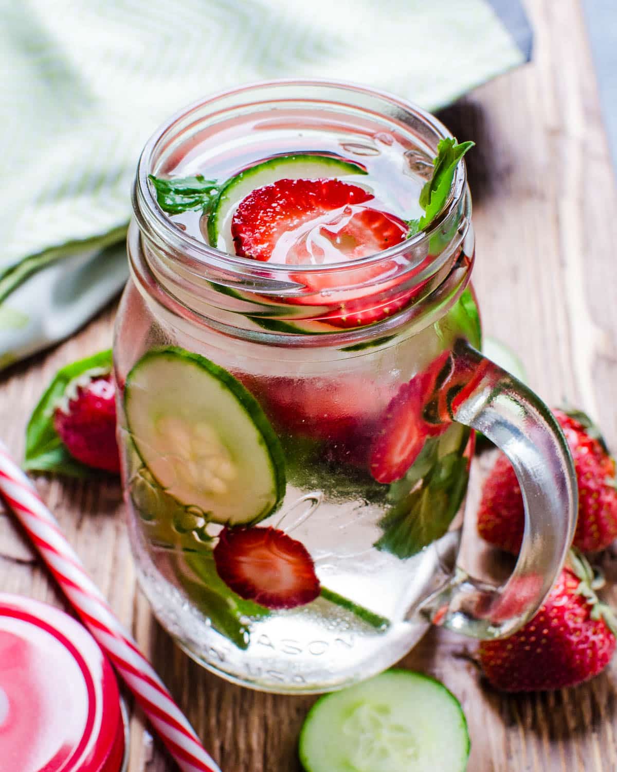 A mason jar filled with strawberry basil spa water.