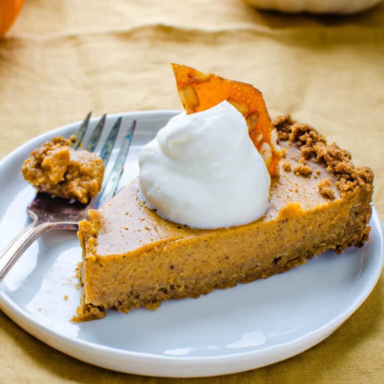 Serving a slice of pumpkin pie with gingersnap crust.