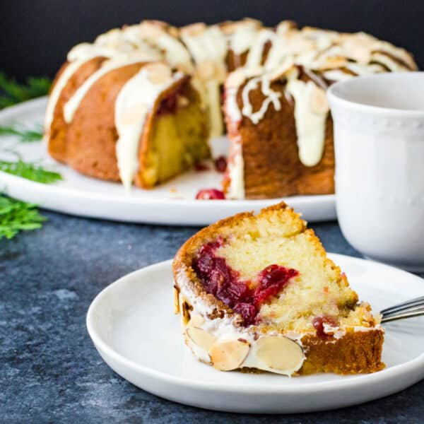 a slice of cranberry coffee cake and a cup of coffee.