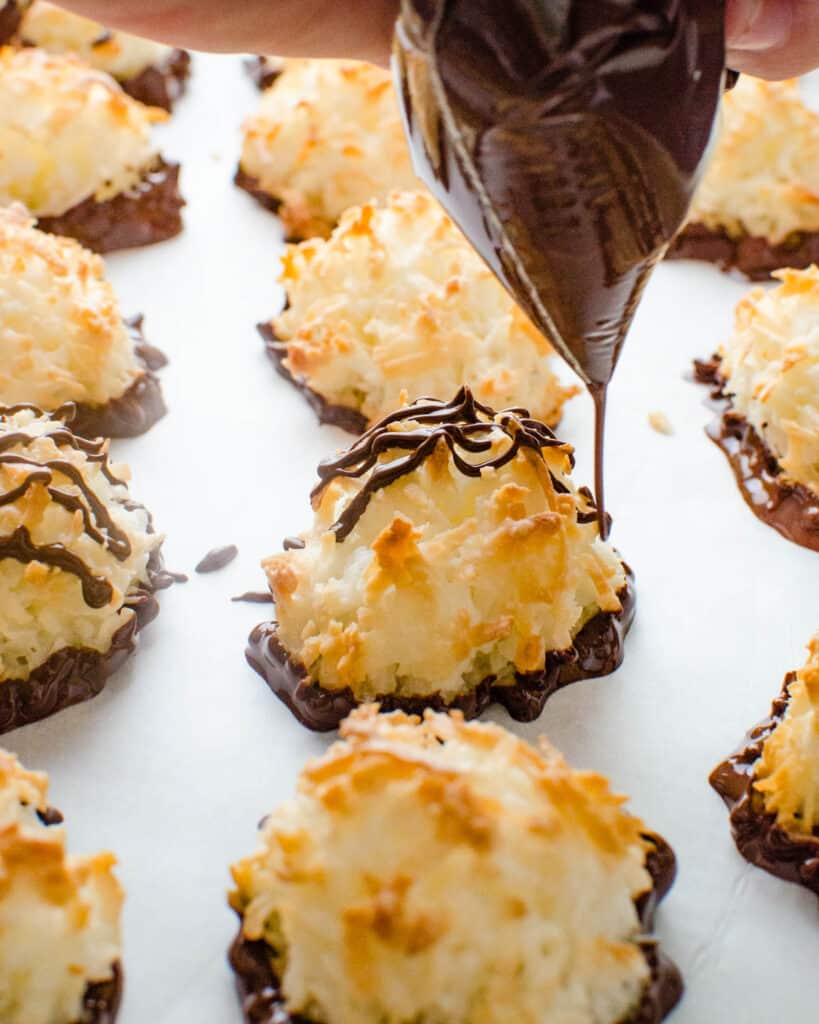 Drizzling chocolate over coconut macaroons.