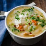 a warm cup of white beans soup with turkey.