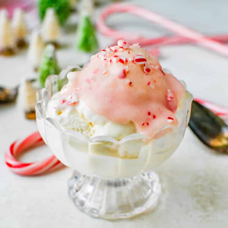 A serving of ice cream with peppermint stick magic shell on top.
