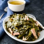 A dish of collard greens with a side of potlikker.