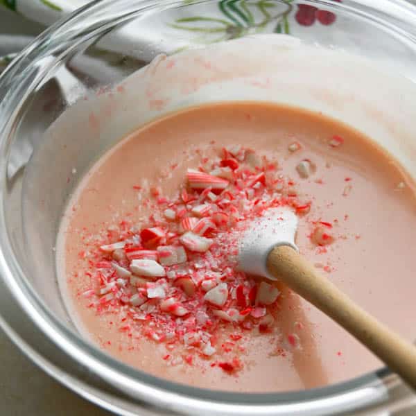 stirring in crushed peppermint stick candies to magic shell recipe.
