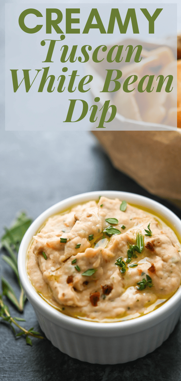 Here's an easy bean dip that's delivers real flavor! Creamy Tuscan White Bean Dip w/ roasted garlic, sun-dried tomatoes & herbs is great football game food! #easybeandip #cannellinibeandip #tuscanwhitebeandip #footballgamefood #gamedaysnacks #whitebeanhummus #roastedgarlic #sundriedtomatoes #hummusrecipe
