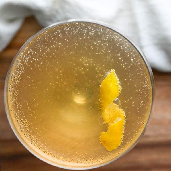 Cognac French 75 in a coupe glass with a twist.