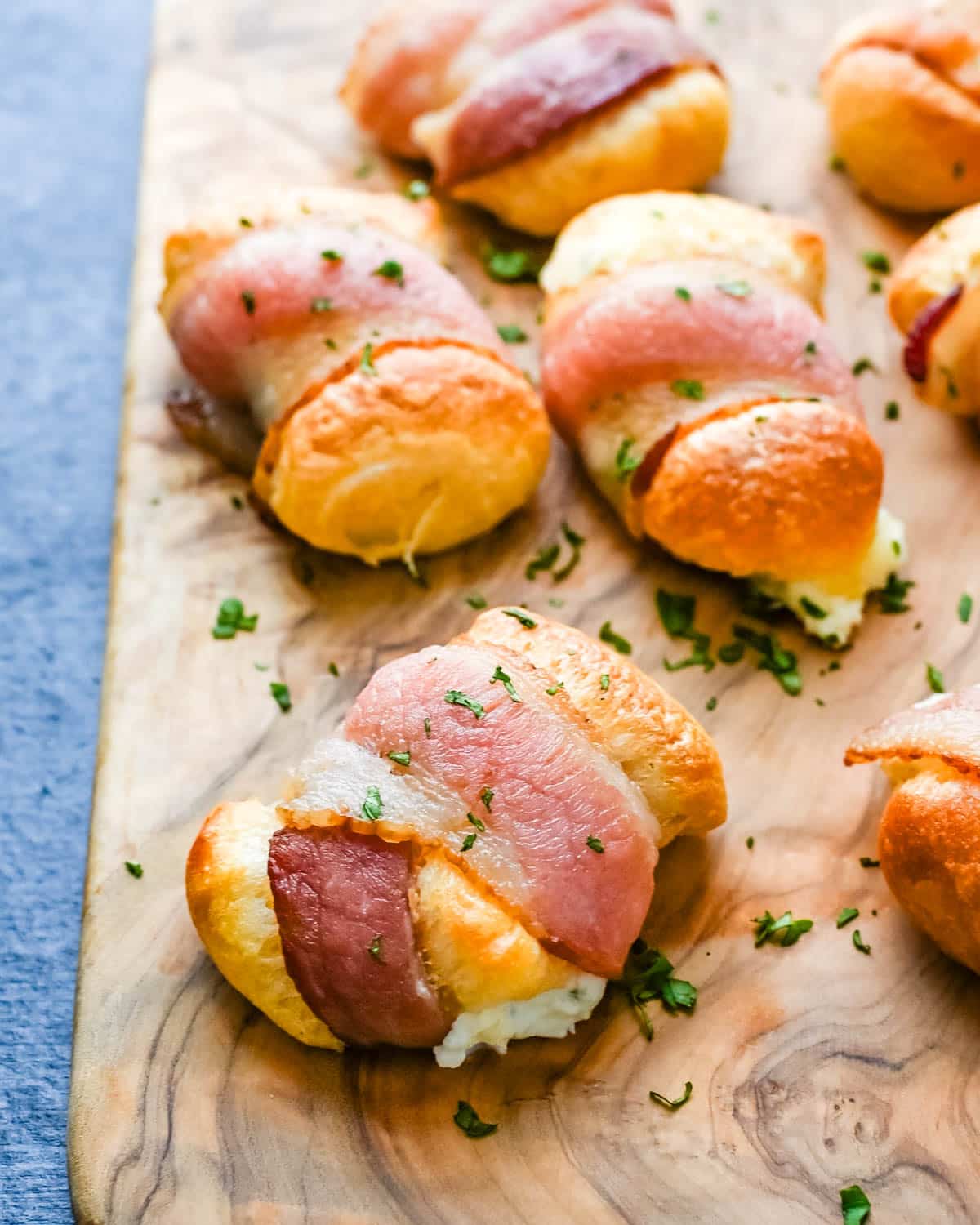 A serving board of bacon wrapped crescent rolls.