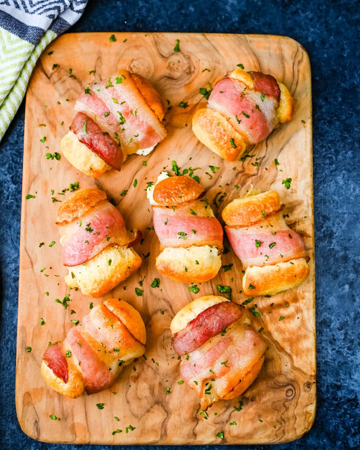 Serving the bacon wrapped crescent rolls.
