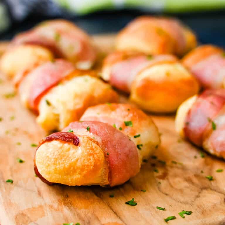 Bacon cream cheese crescent rolls on a serving board.