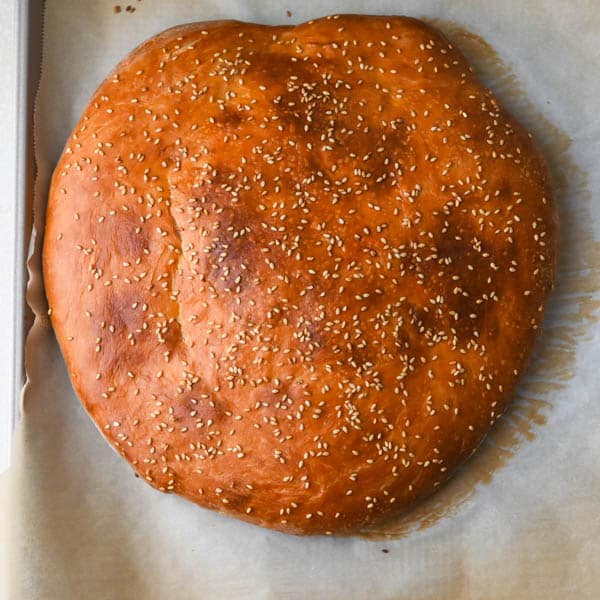 Baked muffuletta bread with golden crust.