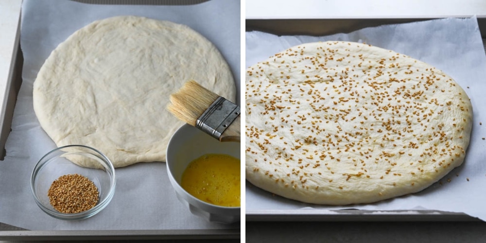 garnishing the round bread with sesame seeds.