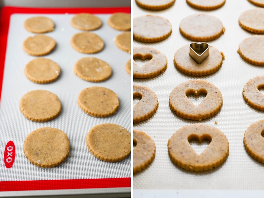 Placing cookies on a baking sheet and cutting out the centers with a heart shaped cutter.