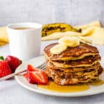 a stack of banana pancakes with syrup.